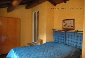 a bedroom with a blue bed in a room at Il Podere Di Giada in Bagni di Lucca