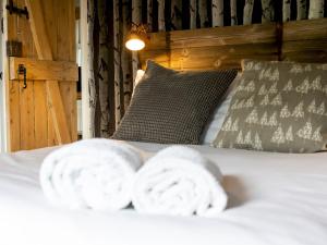 a bed with two towels on top of it at Pass the Keys Explorers Base Camp in Church Stretton