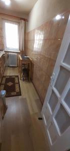 a room with a door and a table and a window at Király Apartman in Gheorgheni +18 photos