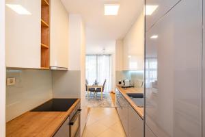a kitchen with white walls and a glass wall at Apartment Keka in Zadar