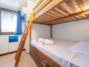 a bunk bed in a room with a ladder at Casa Emanuelle - Near Chia Beach in Chia
