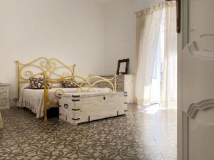 a bedroom with a bed with a wooden dresser and a dresser at Casa Chiara in Lipari
