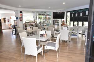 a dining room with white tables and chairs at Castle H 408 in Los Cristianos +15 photos