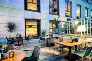 a patio with tables and chairs and a building at Best Western Plus Welcome Hotel Frankfurt in Frankfurt