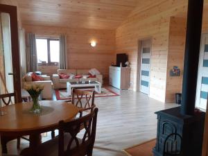 a living room with a couch and a table in a cabin at Forest Edge Lodge in Riga