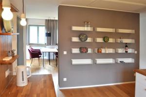 a kitchen with a wall with shelves and a table at Ferienwohnung Zulehenweg 15 in Schönau am Königssee
