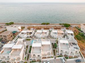 an aerial view of a building next to the ocean at Makrigialos Long Beach Villas - Penthouse 1 in Makry Gialos