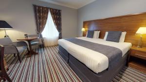 Ein Bett oder Betten in einem Zimmer der Unterkunft Old Thorns Hotel & Resort