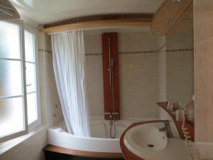 a bathroom with a tub and a shower and a sink at Le Mas de la Frigoulette in Sanary-sur-Mer