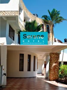 a building with a sign for a savore house at Serene Hotel in Dar es Salaam