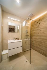 a bathroom with a white sink and a shower at Hotel Csillag Tokaj in Tokaj