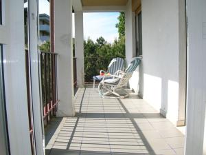 a pair of chairs sitting on a porch at Atticogrado in Lido