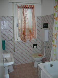 a bathroom with a toilet and a sink at Atticogrado in Lido +55 photos