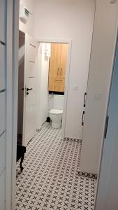 Łazienka z toaletą i podłogą wyłożoną kafelkami w obiekcie APARTAMENT DWUPOKOJOWY w Ostrowcu Świętokrzyskim