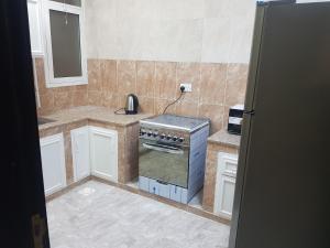 a kitchen with a stove and a phone in it at Today House Suites 2 in Salalah