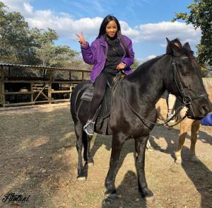 a woman sitting on top of a horse at Fumani Game Lodge in Modimolle