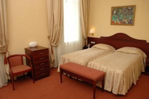 Postel nebo postele na pokoji v ubytování Aurora Premier Hotel