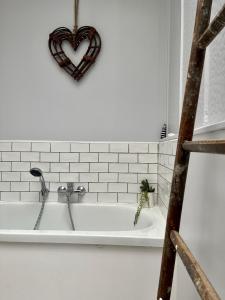 a bath tub with a heart on the wall at Honfleur house in Honfleur