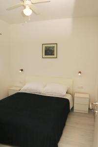 Postel nebo postele na pokoji v ubytování Apartmani Eni