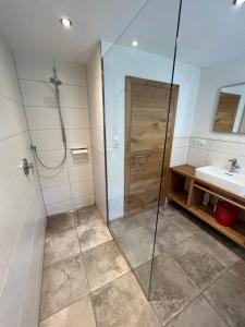 a bathroom with a shower and a sink at Haus Jäger in Lermoos
