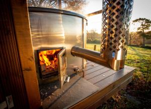 a wood fired oven with a fire in it at Finest Retreats - Chartwell Luxury Dome 