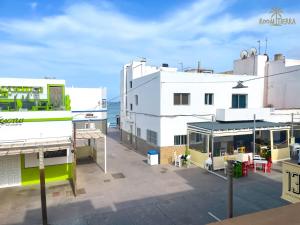 a view of a building with the ocean in the background at Room Tierra wifi free private bathroom , central town in Corralejo