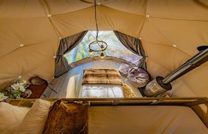 an inside of a tent with a bed in it at Finest Retreats - Knole Luxury Dome 
