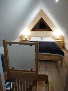 a bedroom with a large bed in a attic at Luna in Poronin