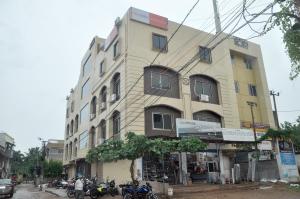 um edifício alto com motos estacionadas em frente em Hotel City View em Bhubaneshwar