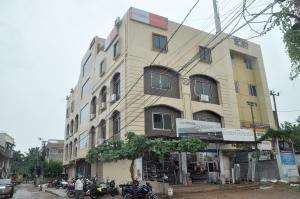 a tall building with motorcycles parked in front of it at Hotel City View in Bhubaneshwar