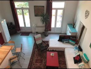 a living room with a couch and a table at Petit paradis in Vic-Fezensac