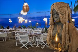 a statue of a woman standing in front of a restaurant at Rammos Managed By Dedeman in Bodrum City