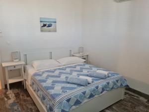 a bedroom with a bed with two pillows on it at Rooms Anđelka in Bol