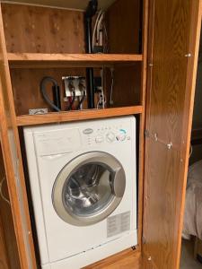 a washer and dryer in a wooden cabinet at Zion RV Stone Pool Inn, Pets stay Free, fenced in yard, relaxing waterfall! in St. George