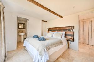 a bedroom with a large bed with a wooden headboard at The Round House in Trentishoe