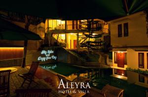 a restaurant with a swimming pool at night at Aleyra Hotel and Villa's Garut in Garut