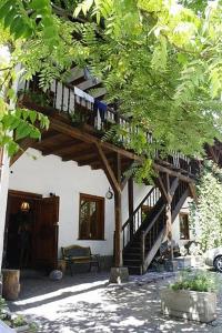 un edificio con una escalera de madera en un árbol en Hostel Mostel Sofia en Sofía