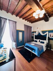 a bedroom with a bed with blue walls and a ceiling at Domus San Martino GuestHouse in Piacenza