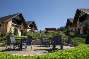 a group of chairs and tables on a patio at Resort Ecoar in Gaspar