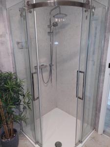 a shower with a glass enclosure in a bathroom at The Old Post Office Exford, Exmoor National Park in Exford