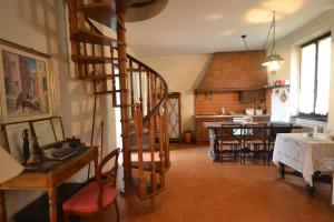 a living room with a spiral staircase and a dining room at Holiday Home Chiavari in Chiavari