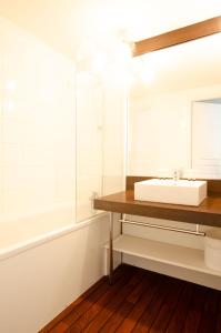 ein Bad mit einem Waschbecken und einem Spiegel in der Unterkunft Appartement 4 personne sur Parc Vacances Richelieu in Chaveignes