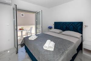 a bedroom with a bed with two towels on it at Villa Ševo Baška Voda in Baška Voda