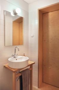 a bathroom with a sink and a mirror at Casa da Praça - Guest House in Pinhel