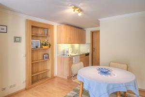 a small kitchen with a table and chairs in a room at Ferienwohnungen Franziska Hackl in Bad Birnbach