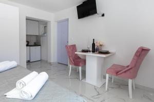 a living room with a table and chairs and a kitchen at Villa Ševo Baška Voda in Baška Voda