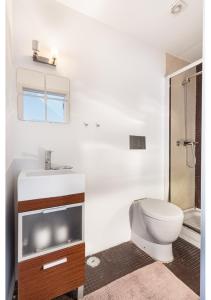 a bathroom with a toilet and a sink and a shower at ALTIDO Stylish 2-bed Apt with balcony in Lapa, 5mins to National Museum of Ancient Art in Lisbon