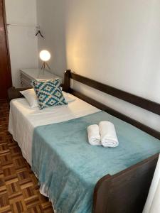 a bedroom with a bed with two white pillows at Apartamento Trav. Santa Luzia in Mirandela +21 photos