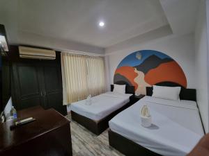 A bed or beds in a room at Sun Moon Hotel