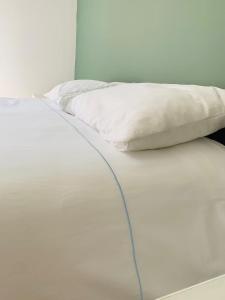 Mezzo House- Entire property في كوفينتري: سرير ابيض عليه مخده بيضاء